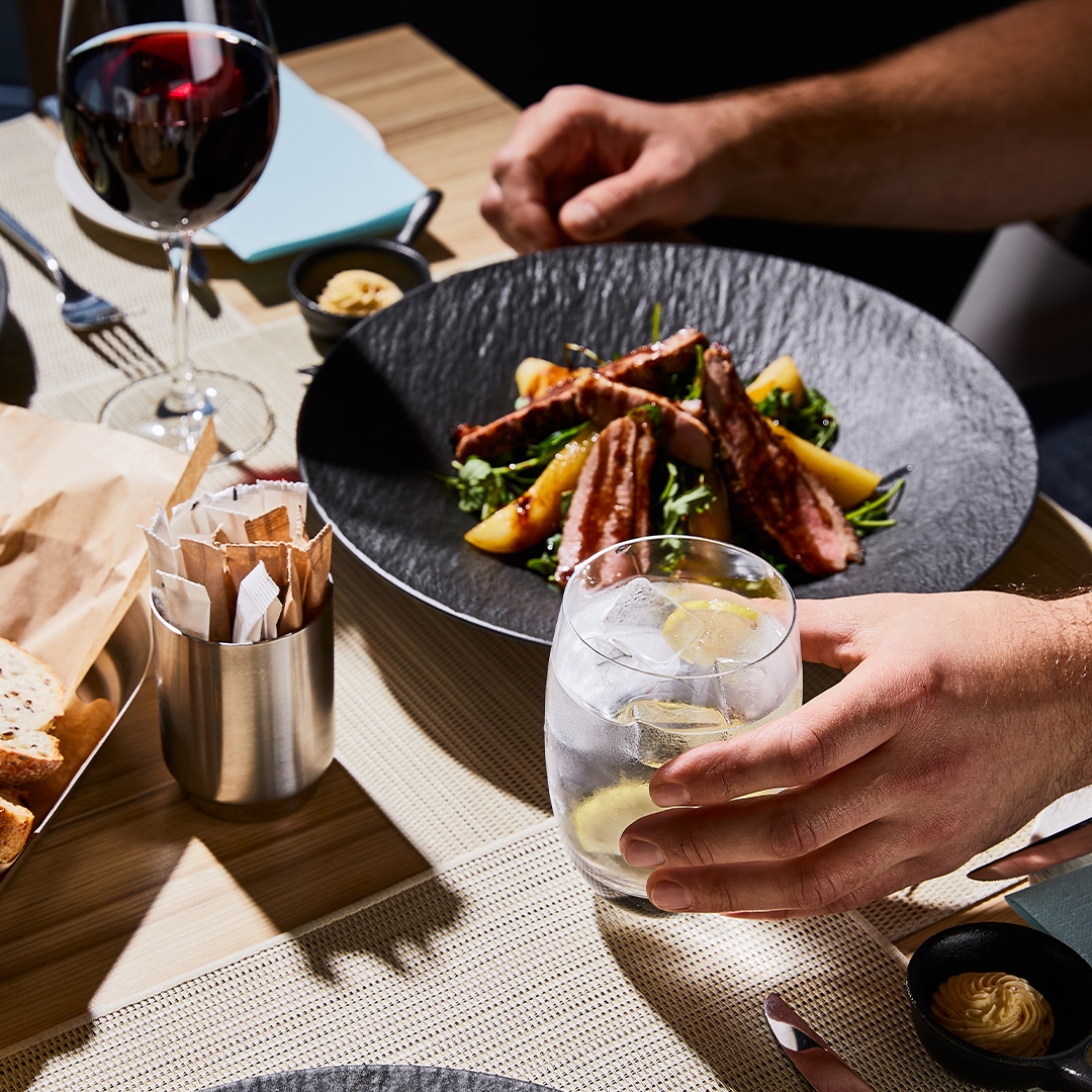 Fine dining with a meal of steak on salad.