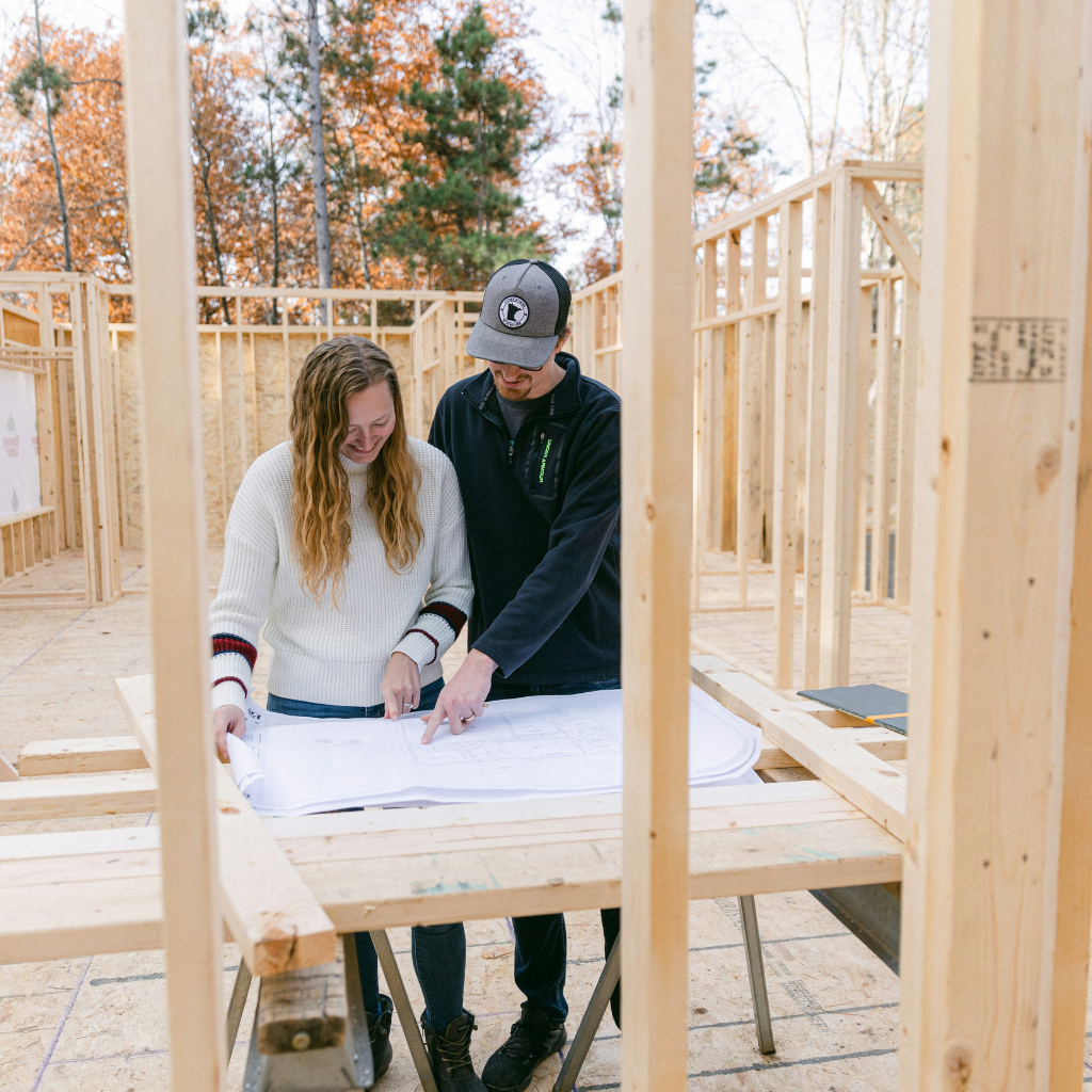Couple review architecture plan of their new house