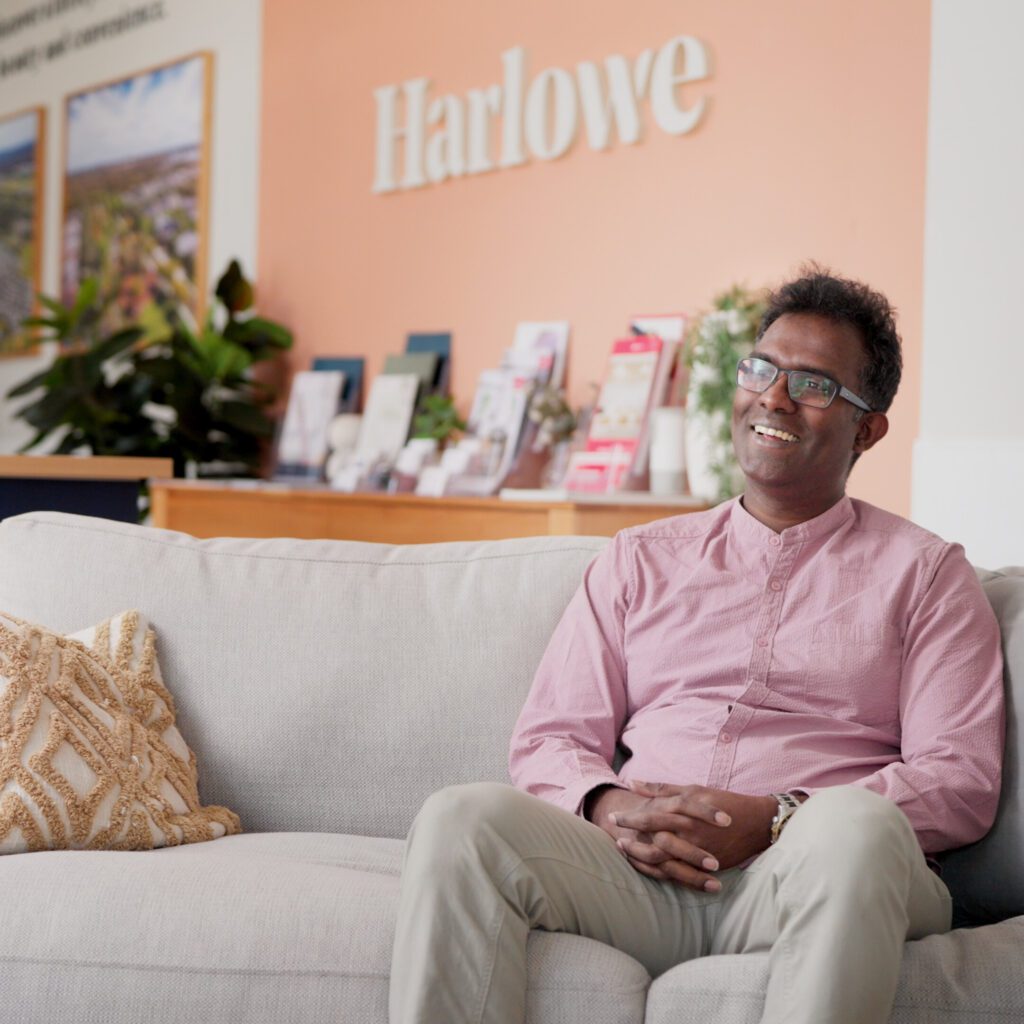 Man sitting on couch in Harlowe waiting room